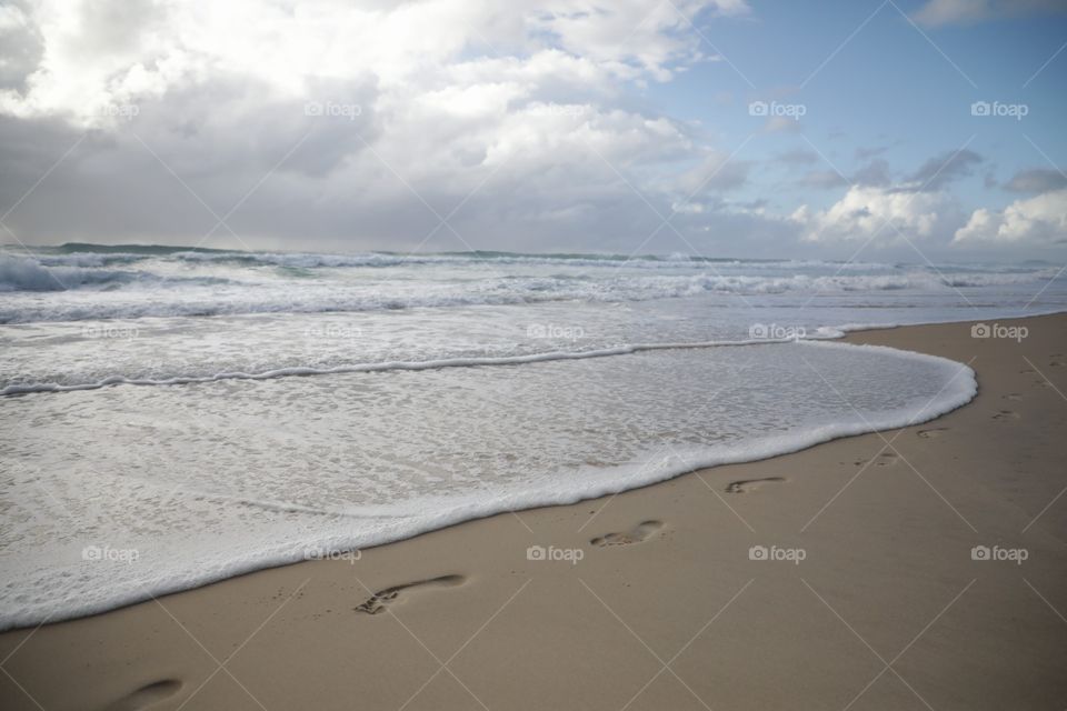 Wave foam and footprints