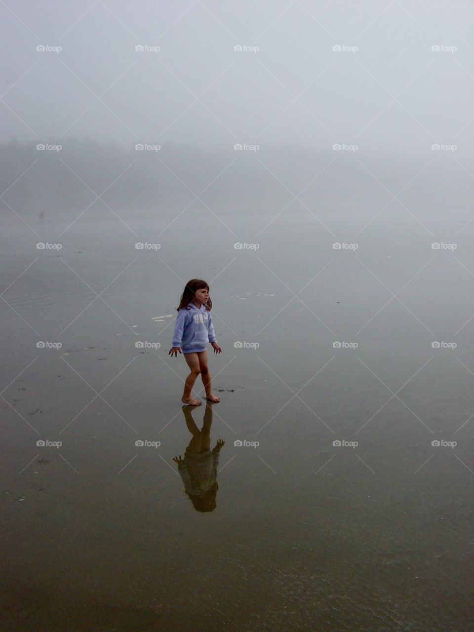 Child on the foggy beach