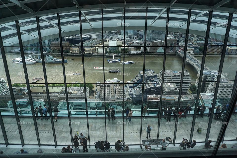 People looking through an enormous window at The Sky Garden London 🇬🇧