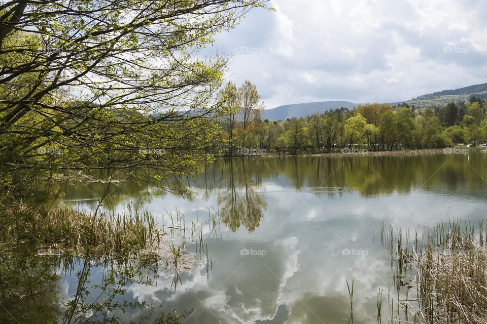 Beautiful view of lake Pancharevo near Sofia, Bulgaria. Reflection of trees and sky in the water
