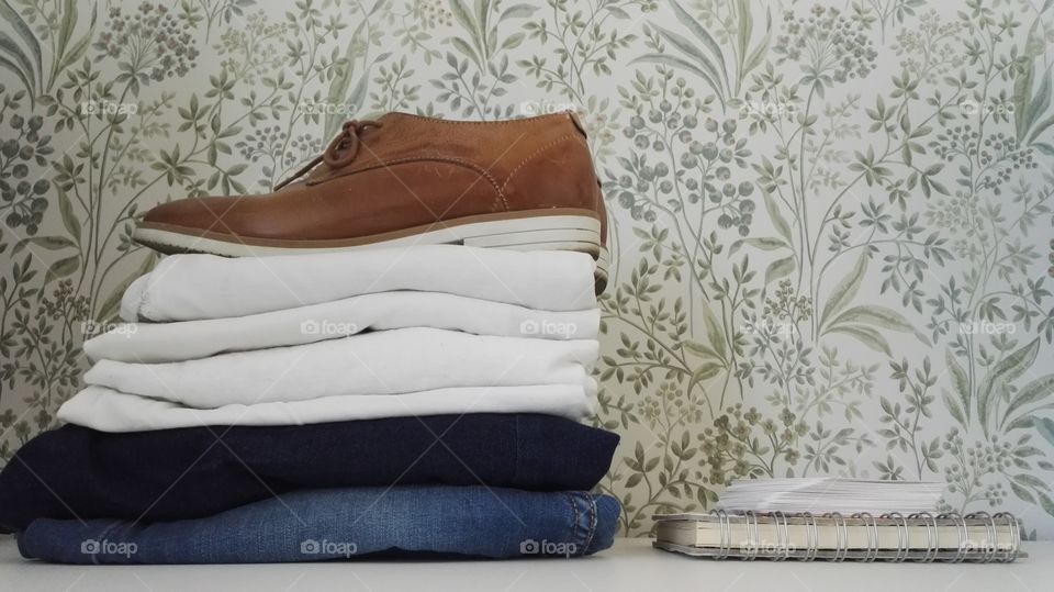Packing simple way for a vacation. Brown shoes white t-shirts blue jeans.