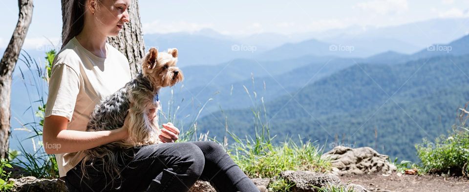 happy caucasian woman in mountain with her dog