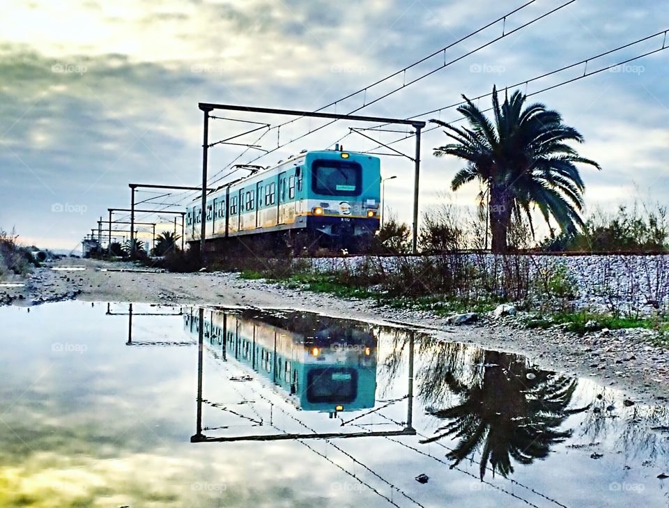 train passing by and its water reflection 
