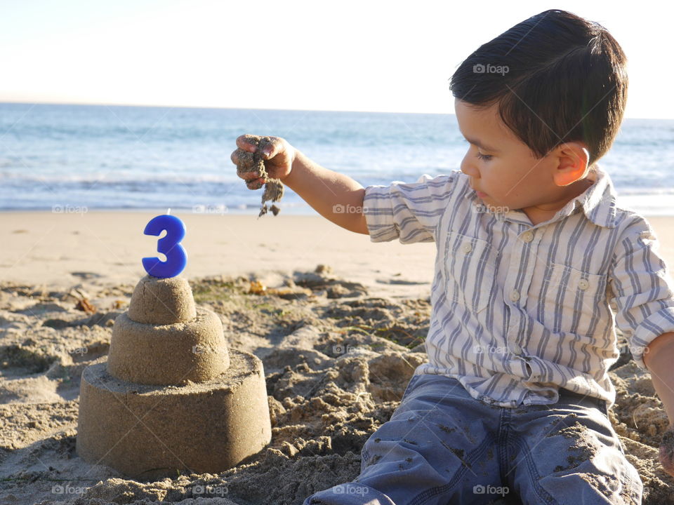 Cute boy playing on beach