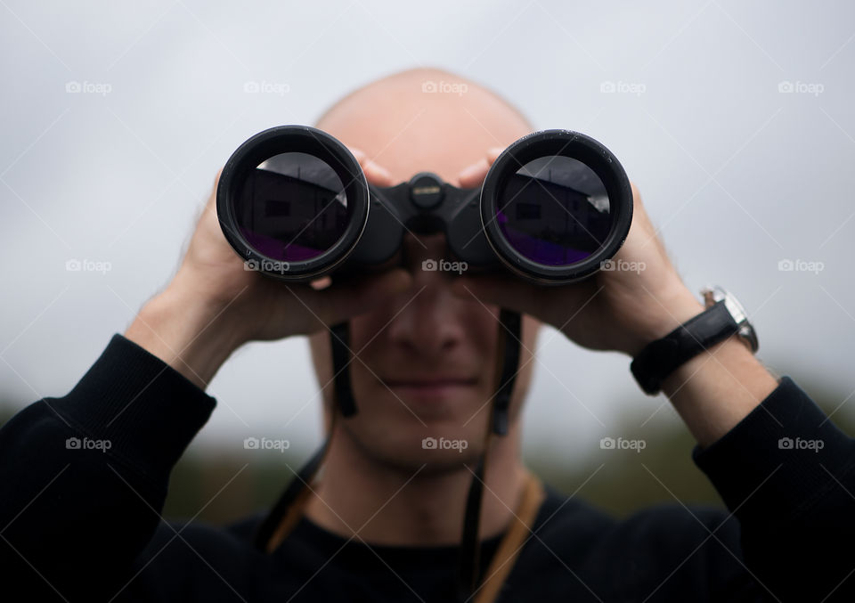 Man looking through binoculars