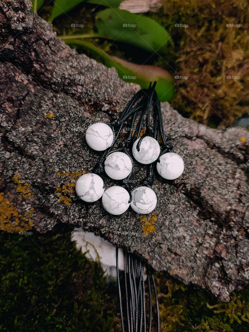 White natural stone beads howlite on black cord. Gemstone chockers close up, stone jewelry