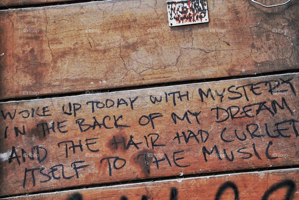 Graffiti. Graffiti poetry on a wall in Rome 