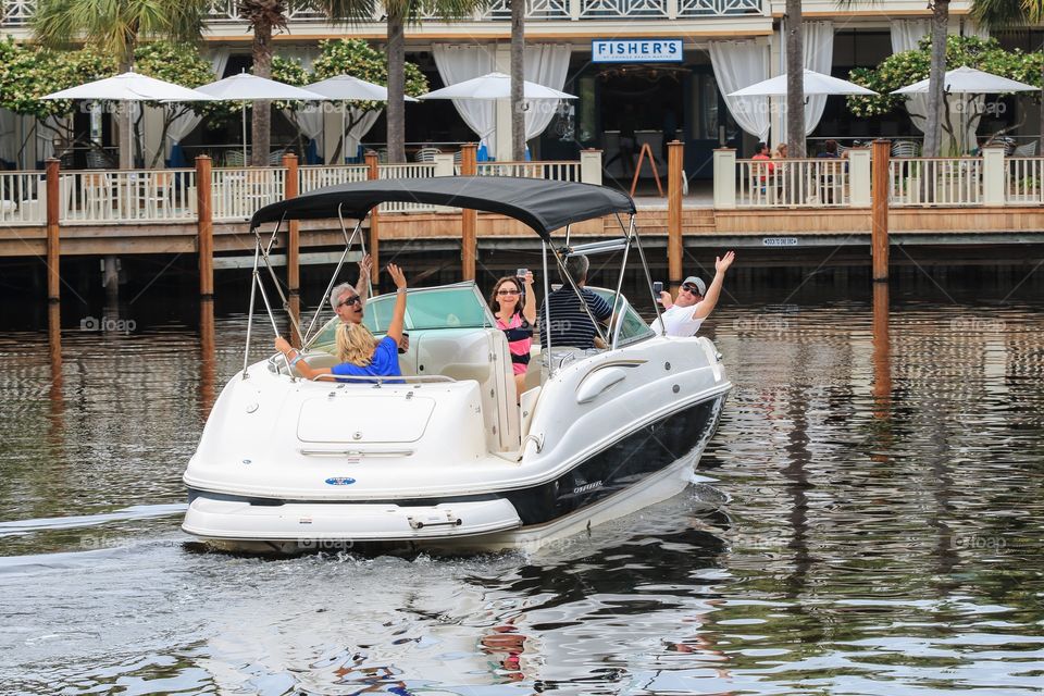 Family people going to the restaurant by boat