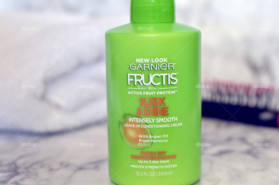 Garnier sleek and shine leave in hair conditioner on a marble background 