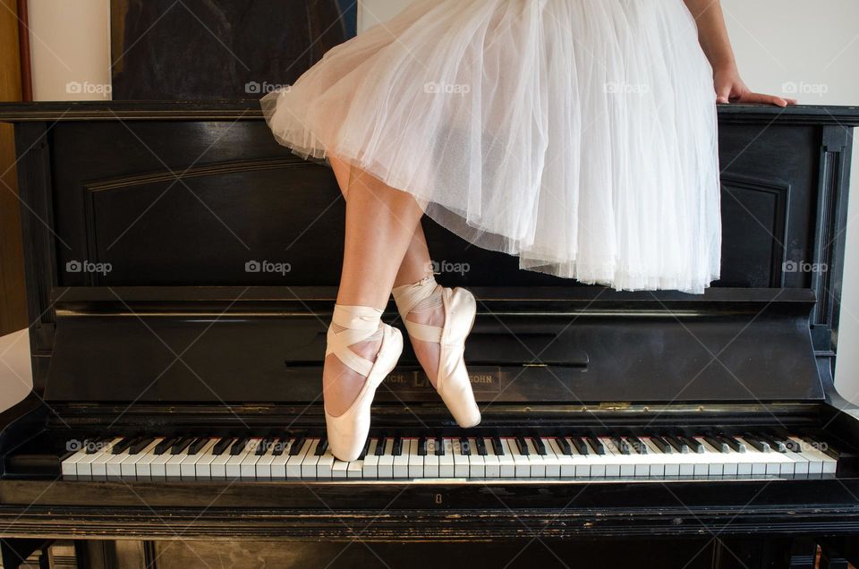 Ballerina Standing on A Piano