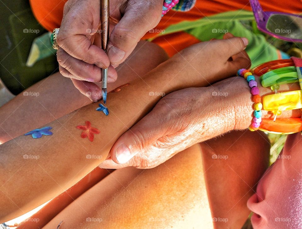 Old hands doing arm painting