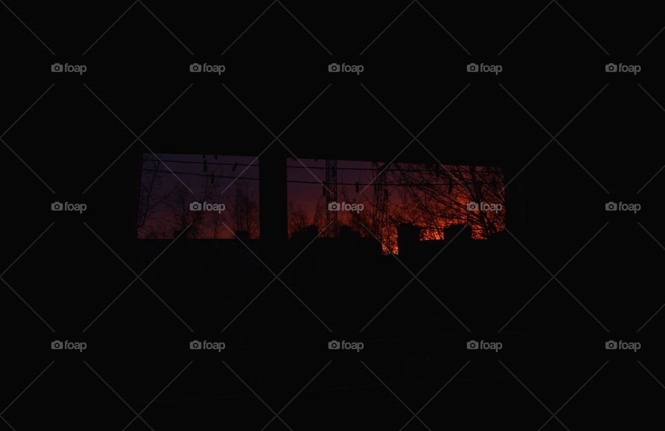 silhouettes houses roof evening window view on a sunset