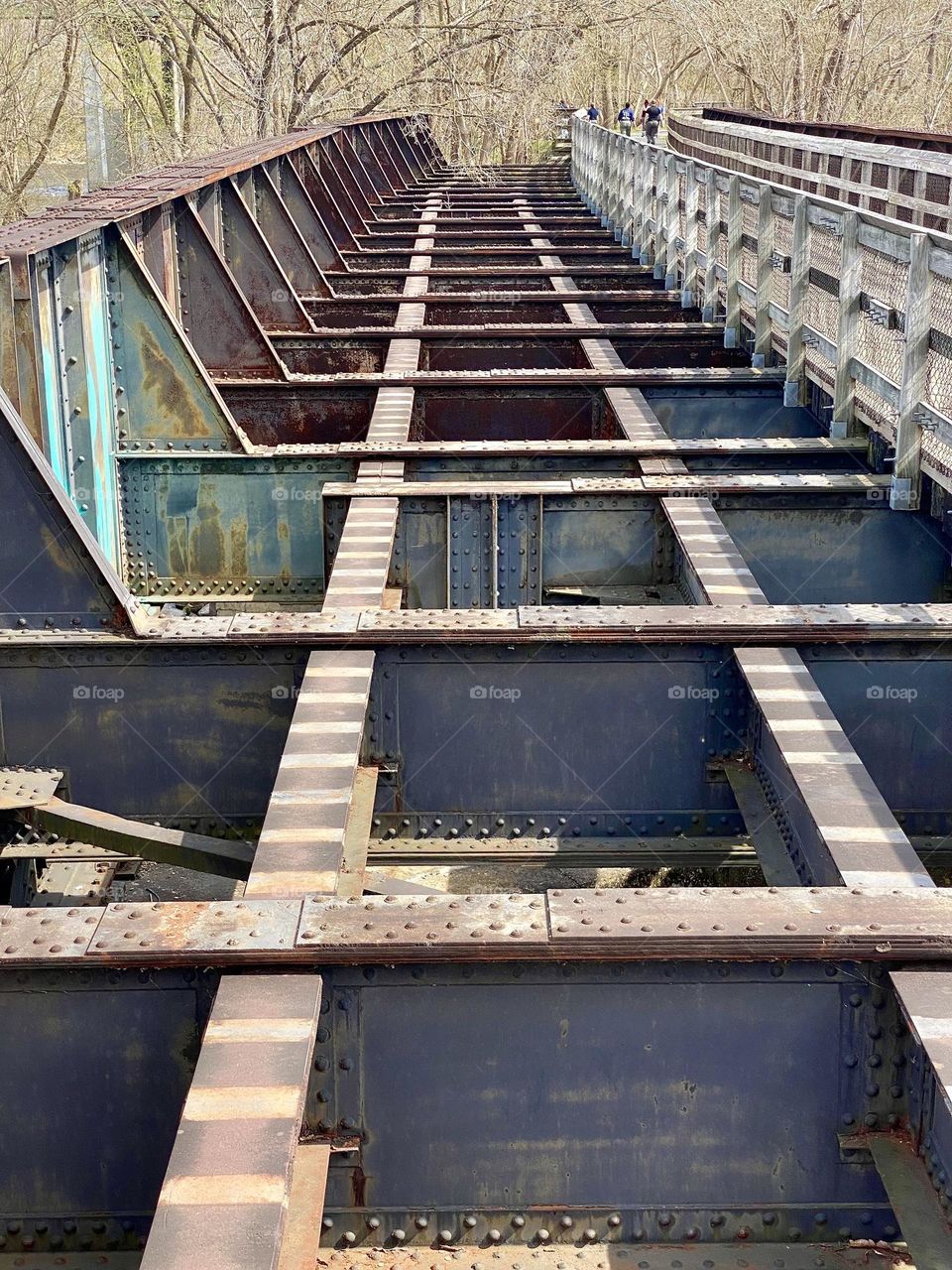 An old railway bridge and a footpath across a river 