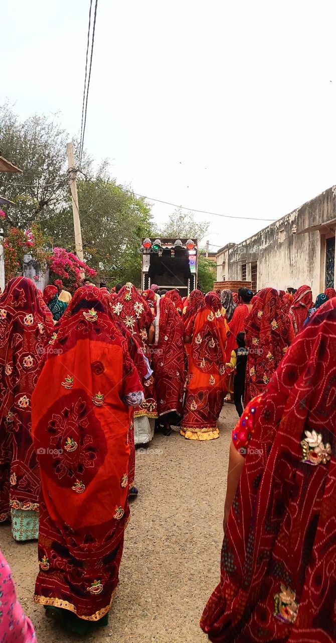 Ladies enjoying a function of marriage in one of the street of Rajasthan, India. Dancing near DJ local band music. All pretty dressed up in beautiful colourful attires holding their own value.