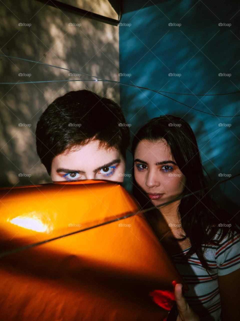 Two models looking at the camera, With a orange and blue contrast on the foreground, background and the make-up of the girls.
There's a custom lighting in the background, with direct flash on the girls.