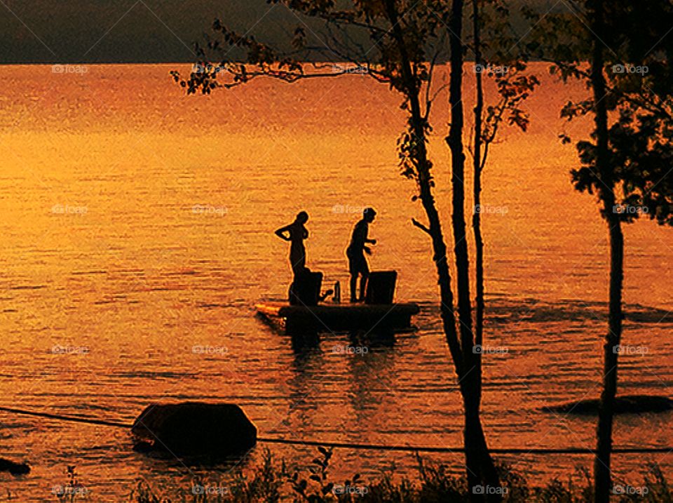 Silhouette youth on lake raft. Silhouette youth on lake raft