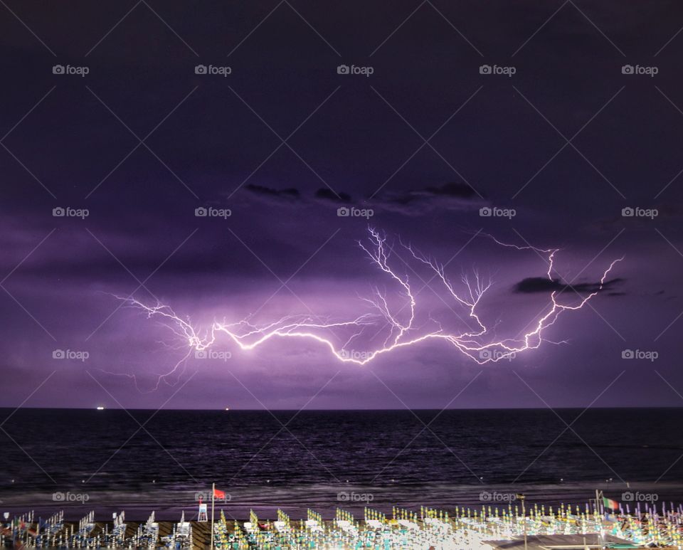 Thunderstorm and lightning over the sea at night