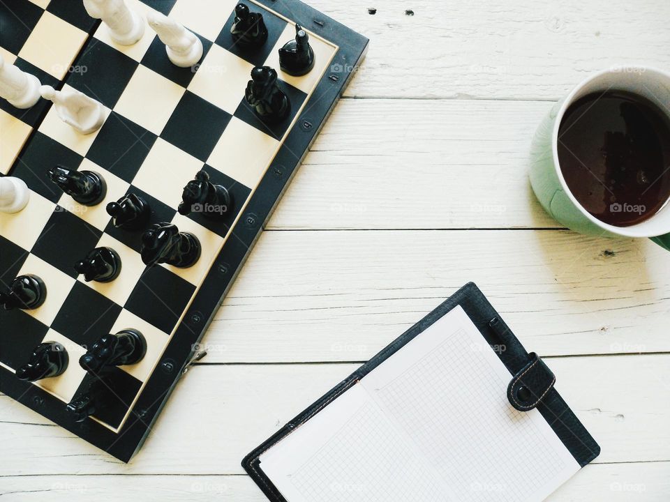 Cup of coffee near chess board