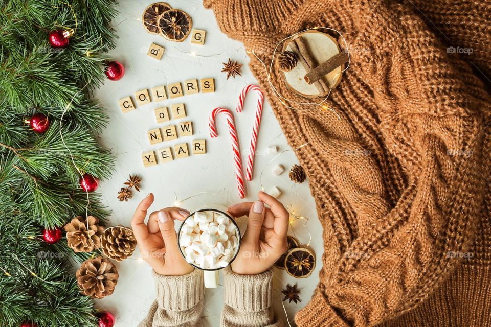 Flat lay with hot cocoa and knitted sweater 