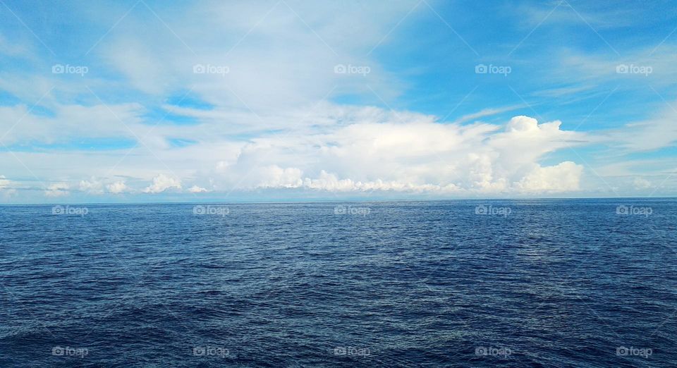 Cloudscape on the sea, abstract "crocodile and bird" by cumulusnimbus and cirrostratus clouds.