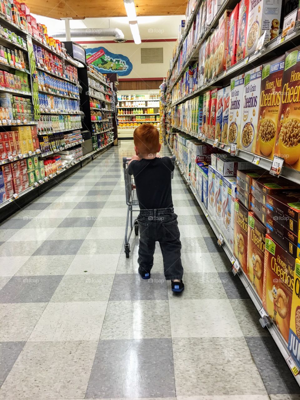 Toddler shopping at the grocery store 