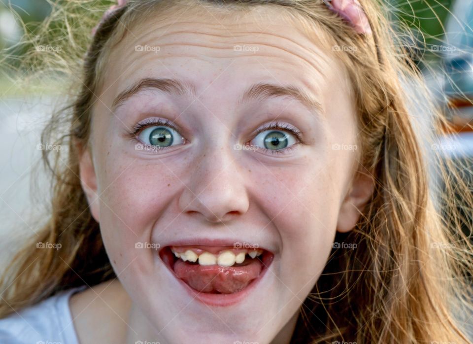 Funny kid sticks out tongue and acts surprised selfie 