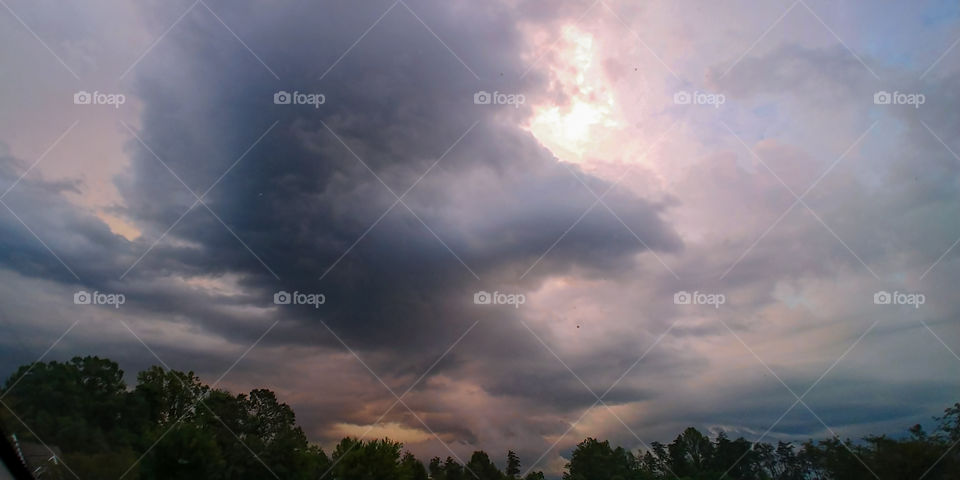 A storm brewing off in the distance with ominous dark colored swirling clouds