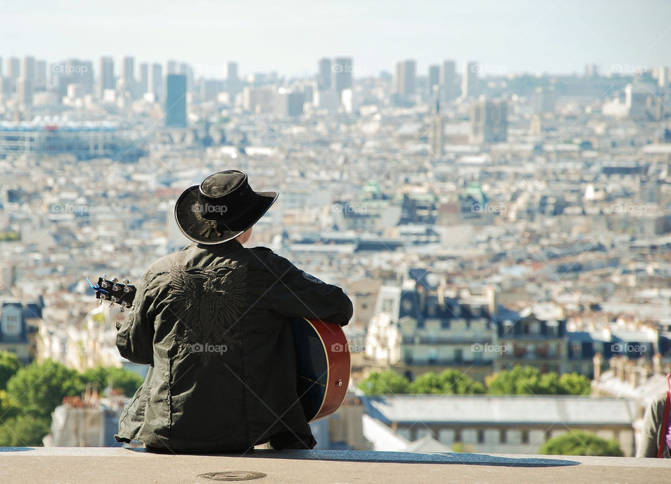 Guitarist above the city . Shoot at the Sacre coeur, Paris 