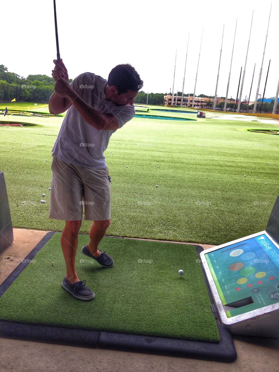 Golf Master. Man golfing at Top Golf