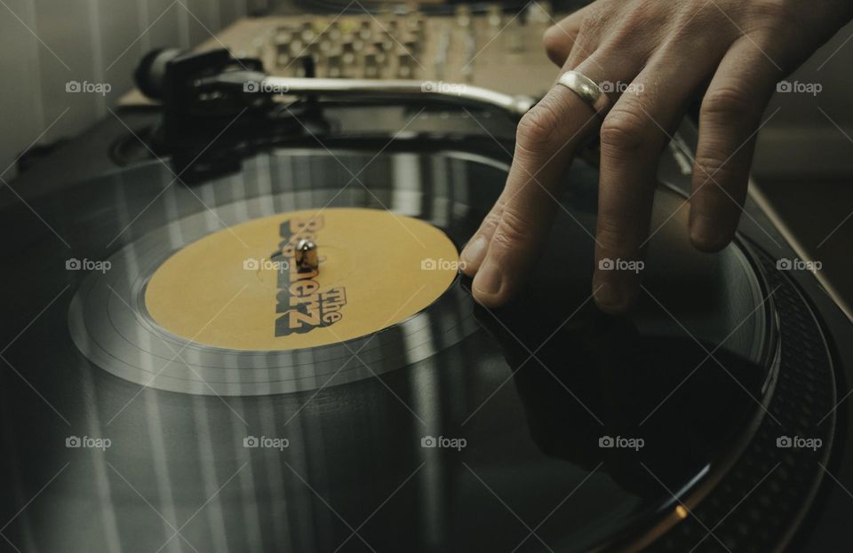 DJ with his fingers on a vinyl record