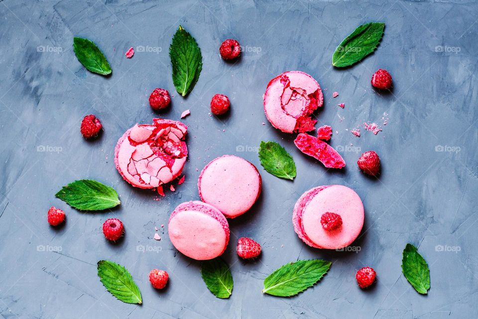 Flat lay of cookies with raspberries and mint leaves on gray background 