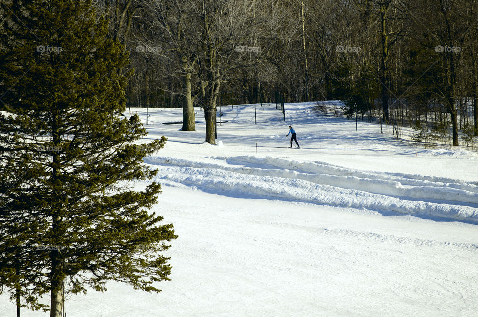 Winter landscape with snow covered mountain and cross country skiing on a sunny day 