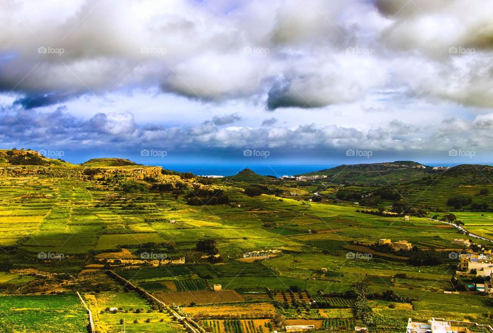 The rolling, green hills of Gozo on a cloudy, windy day. 