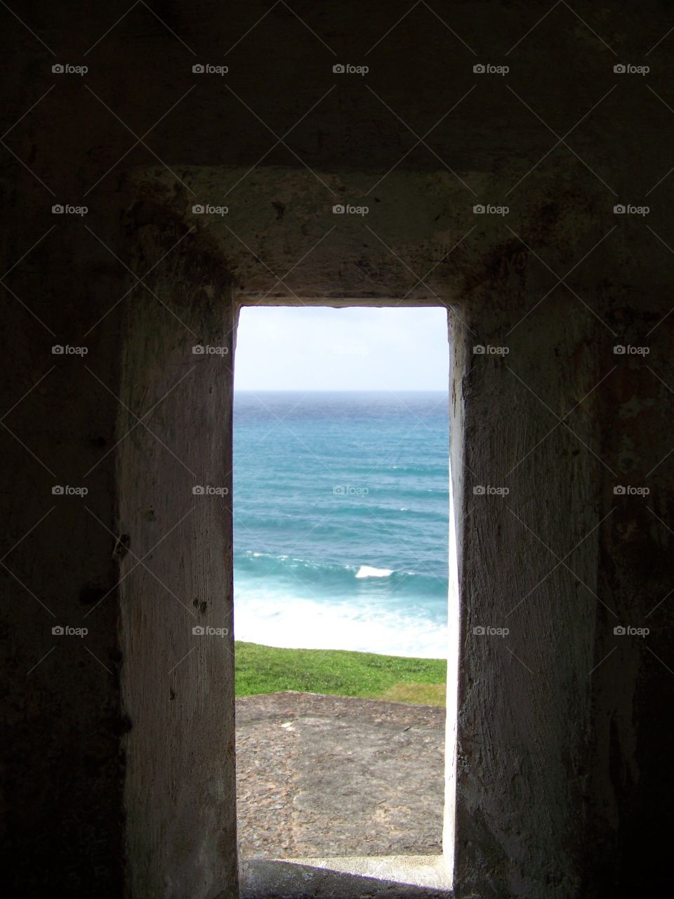 View of the beach through a doorway of fort El Morro Puerto Rico