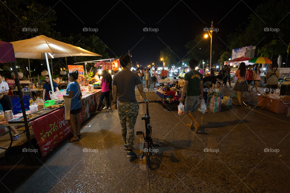 Man with bike in street market 