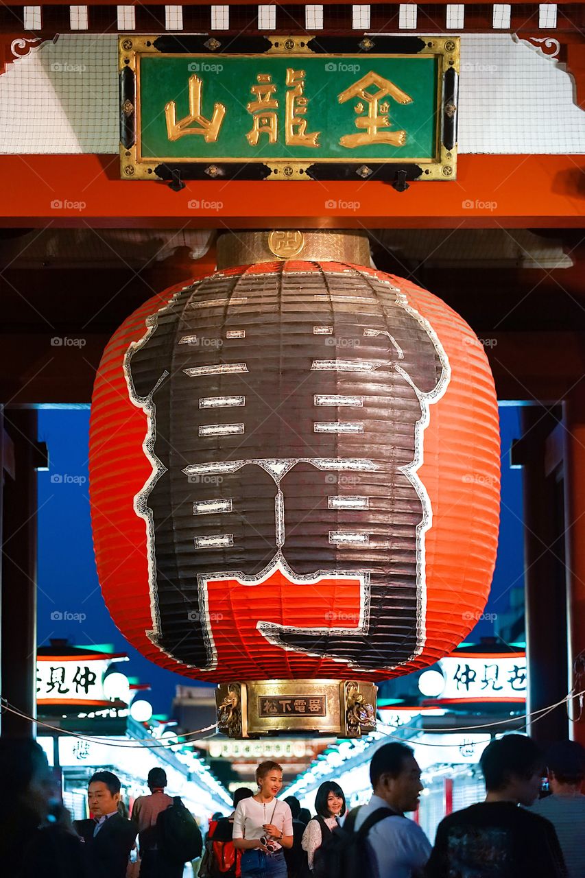 Tokyo, Japan - May 15, 2018 : A photo of giant red lantern at Asakusa Sensoji Temple. On a lantern is Japanese word meaning thunder gate or Kaminarimon Gate. Asakusa Sensoji Temple is one of the most tourist attraction spots in Tokyo.