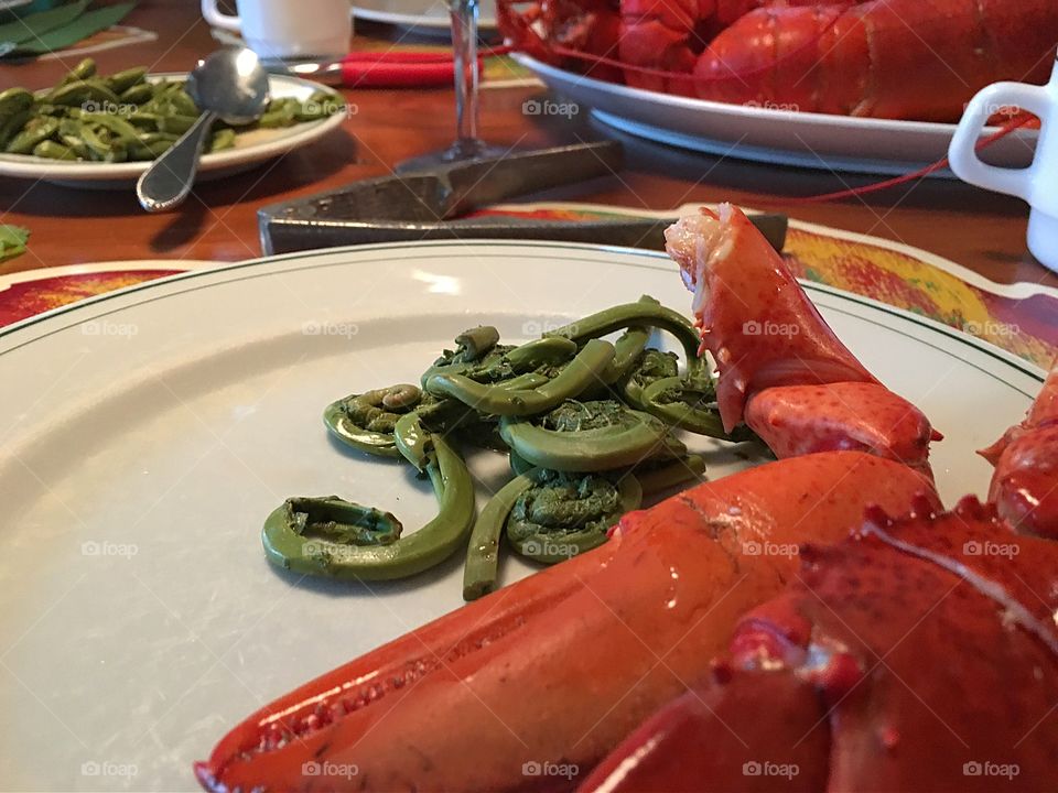 Lobster feast, fresh lobster lobster tail closeup, and fresh wild fiddleheads as a
Side. Yum!