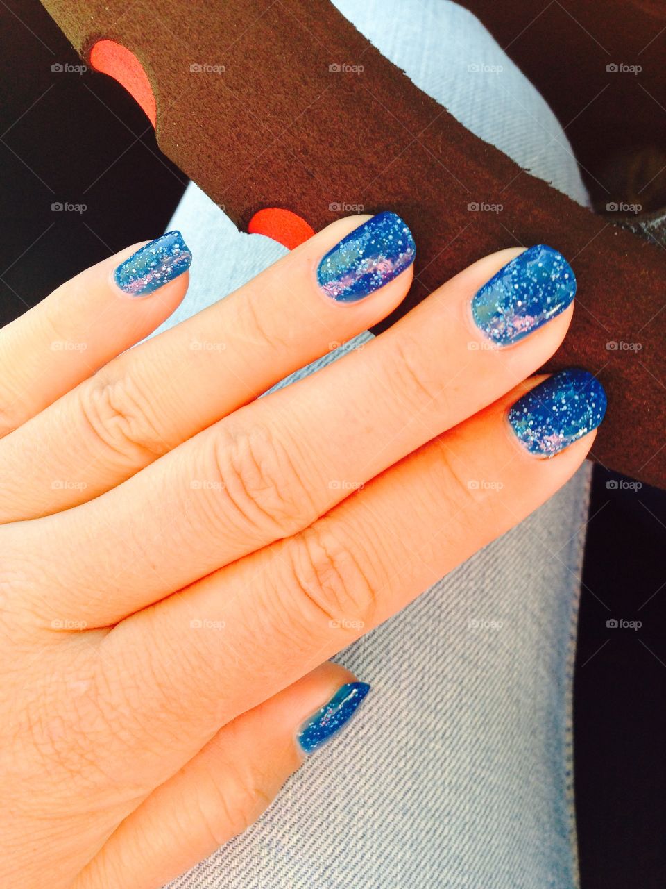 blue manicure while driving