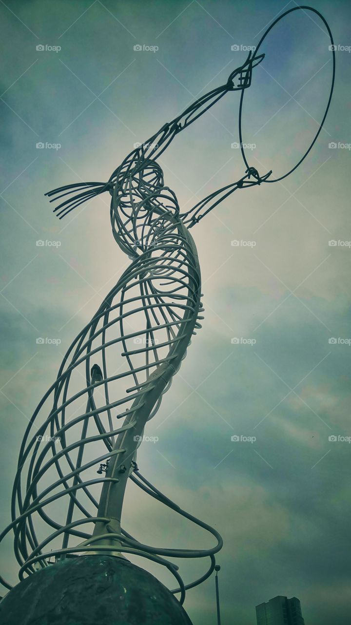 Under an eerie statue on the streets of Belfast