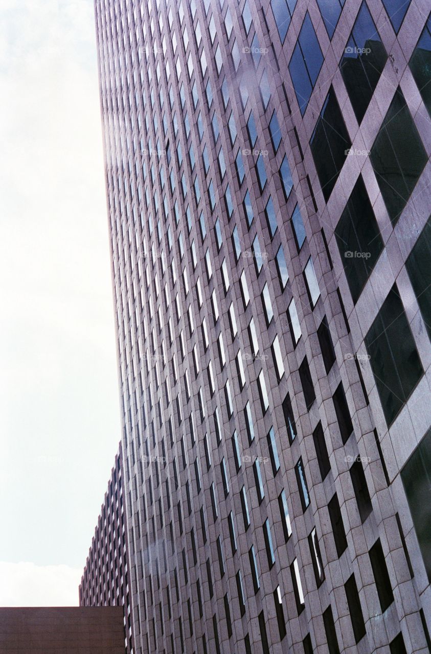 Angle with sun flare of high rise office building on film. 