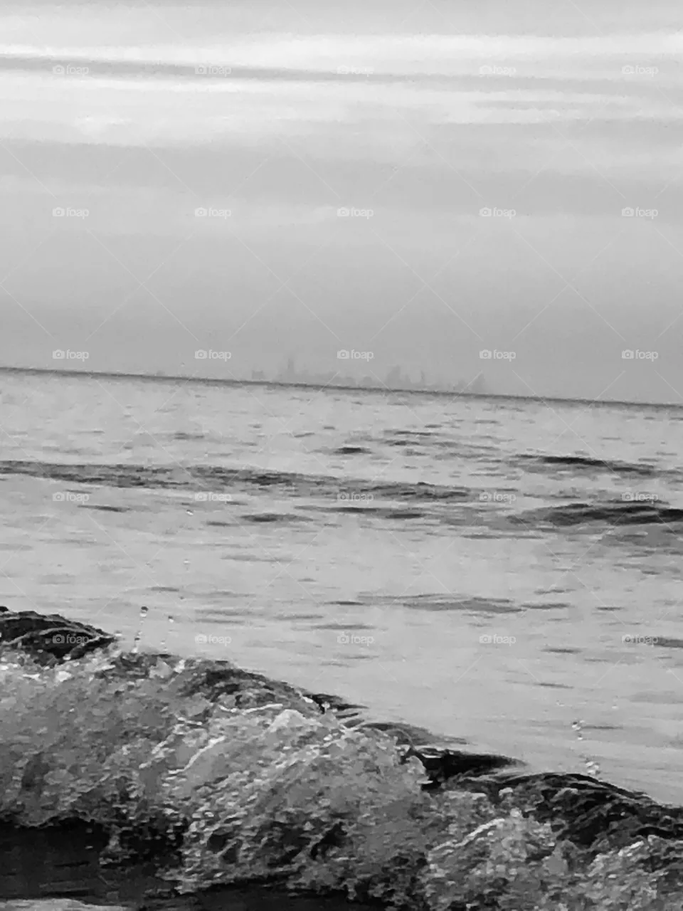 Black and white picture of the white capped waves crashing into the sandy beach. Portage beach and  River Walk, Portage IN