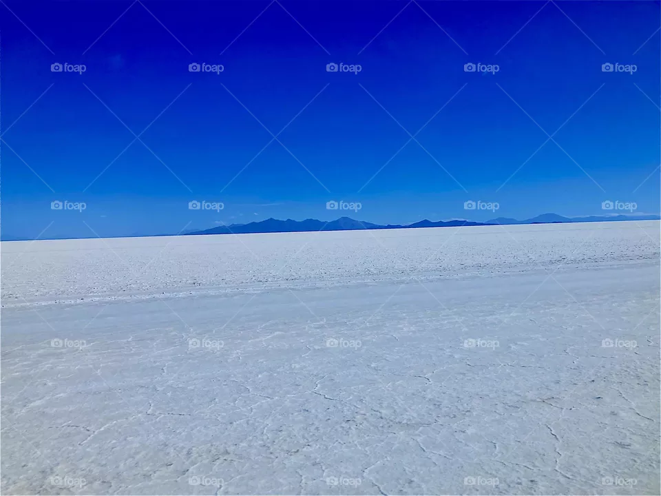 This white landscape is the dry area of the “Uniyuni Salt Lake” in “Bolivia” in “Central America”. It is entirely made up of white salt deposits at the shores of this gigantic lake. 2022. Hypnotic Productions