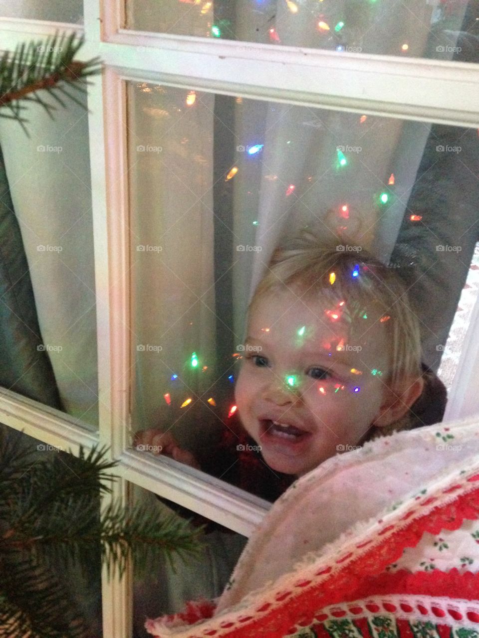 Little boy looking through the glass window