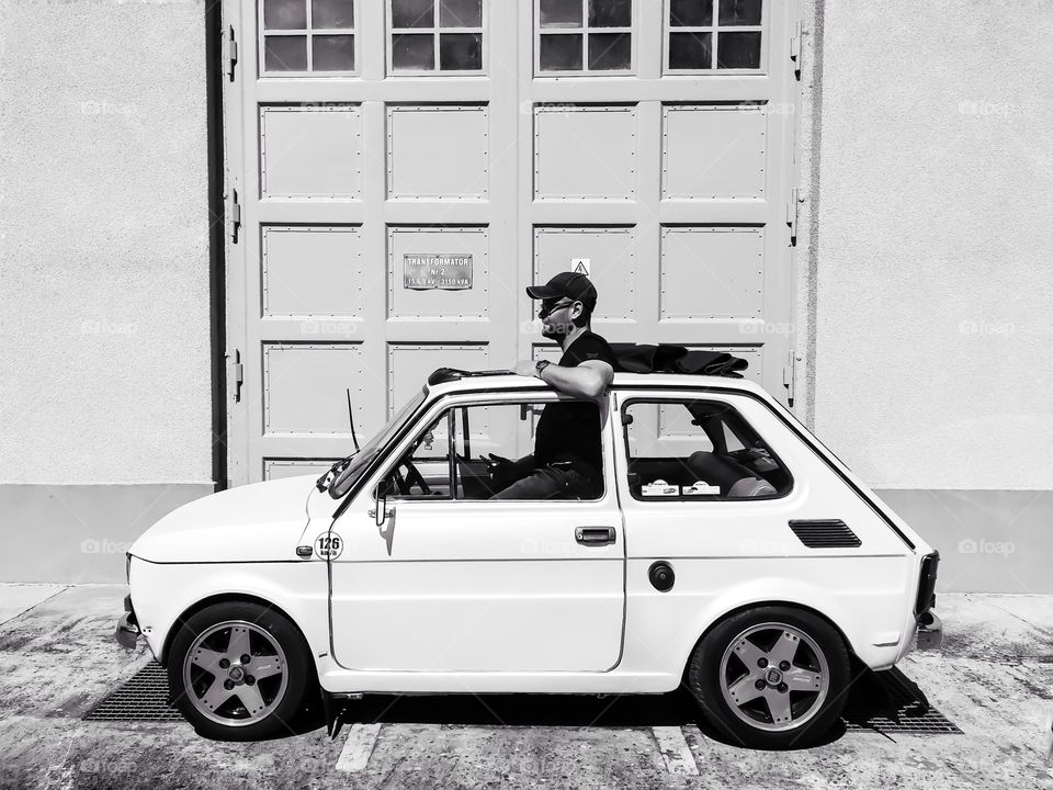 Man sitting in the small car