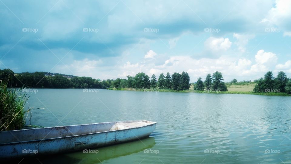 Fishing boat on the lake. Summer lake viee