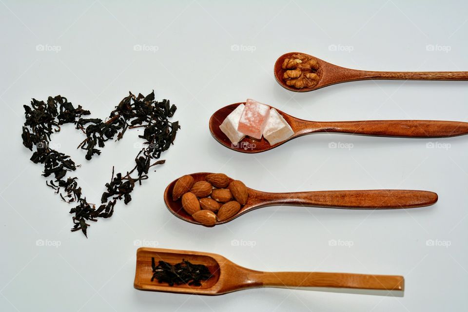 tea heart and healthy food on a wooden spoon top view table background